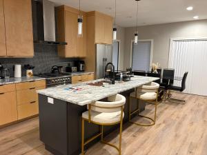 a kitchen with a large island with bar stools at 1st Luxury Residential Elevator rooftop deck in Rochester