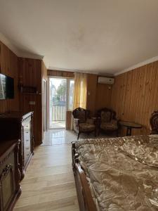 una camera da letto con un letto e una porta scorrevole in vetro di Guest House Mari a Ureki