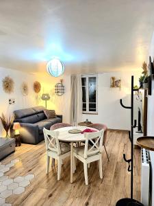 ein Wohnzimmer mit Tisch, Stühlen und Sofa in der Unterkunft Maison de ville Chaleureuse au cœur de Chartres Netflix, garage vélos in Chartres