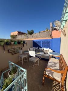 马拉喀什La Petite Maison - Dar El Bacha的阳台配有沙发和桌椅。