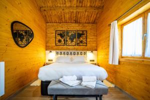 a bedroom with a bed in a wooden room at El Freginal in Olocau del Rey