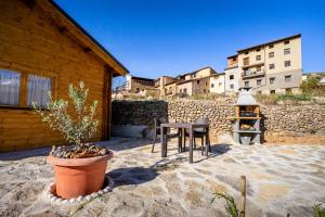 a patio with a table and a fire place at El Freginal in Olocau del Rey