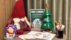 a table with a santa claus toy and a christmas tree at Hampton By Hilton Venice Isola Nuova in Venice