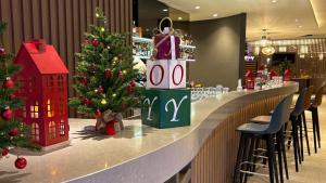 a christmas tree sitting on a bar in a restaurant at Hampton By Hilton Venice Isola Nuova in Venice