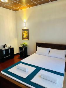 Ένα ή περισσότερα κρεβάτια σε δωμάτιο στο Sigiriya Arecanut Garden