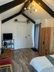 a bedroom with a bed and a tv in a room at Mountain lodge in Dundalk