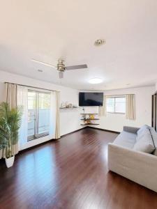 a living room with a couch and a flat screen tv at hibiki hotel osaka in Osaka