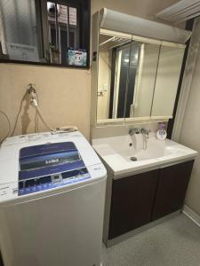 a bathroom with a sink and a mirror at hibiki hotel osaka in Osaka +23 photos
