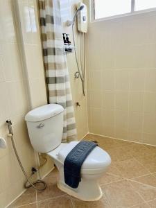 a bathroom with a toilet and a shower at Calm Stay & Cafe in Chiang Mai