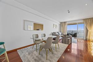 迪拜Burj View Luxury 1BR - Full Sea View Private Beach - Anantara Palm的带桌椅的客厅