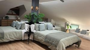 a large bedroom with two beds and a couch at La Hondonada in Somo +48 photos