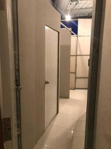 an empty hallway with a white door in a room at Reaksa Hostel & Spa - Koh Rong in Kaôh Rŭng (6) +6 photos