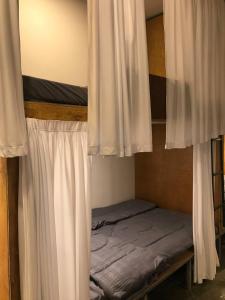 a bedroom with two bunk beds with white curtains at Reaksa Hostel & Spa - Koh Rong in Kaôh Rŭng (6)