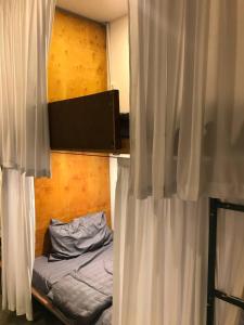 a bedroom with a bed with white curtains at Reaksa Hostel & Spa - Koh Rong in Kaôh Rŭng (6) +6 photos