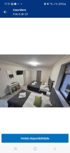 a picture of a bedroom with two beds in a room at Casa Marm in Călimăneşti