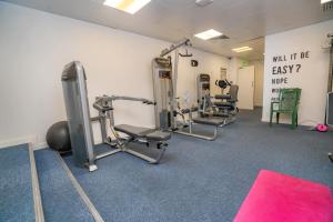 a gym with treadmills and weights in a room at Lovely Modern Central Coventry Budget Studio in Coventry