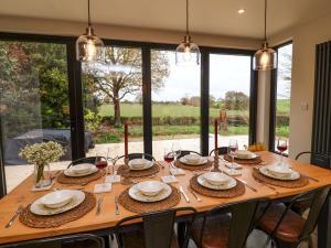 a dining room table with glasses of red wine at Fairview in Saxmundham