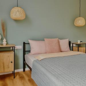 a bedroom with a bed with pink pillows at ZiAna - Hiperbara Livezeni in Livezeni