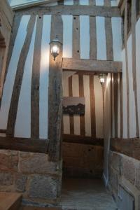 
an old wooden structure with a wooden door at Logis Saint Eloi in Rouen
