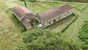 an aerial view of an old building in a field at Le chene vert in Saint-Front-de-Pradoux