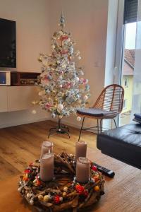 a christmas tree with candles in a living room at Apartments bei Playmobil 1,130m2,24h Self Check-in, free Parking in Zirndorf