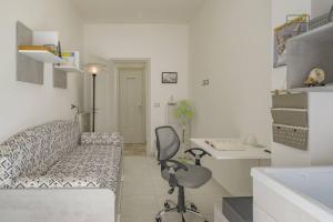 Zimmer mit einem Sofa, einem Schreibtisch und einem Stuhl in der Unterkunft Peace House - Relax a Due Passi dal Mare in Finale Ligure