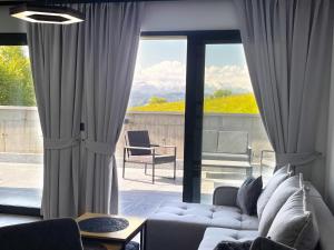 a living room with a couch and a large window at Willa Pienińska 123 in Maniowy