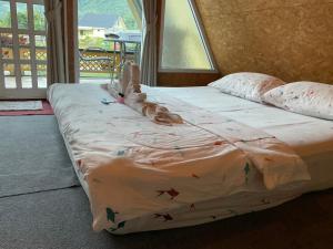 a large bed in a room with at Mountain Deer Resort & Camping in Ban Mung