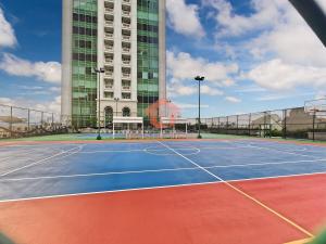 a tennis court in front of a building at Strategic 1BR Bellezza Apt Green Gem Max 6 in Jakarta