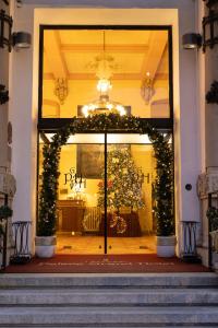 a front door of a store with a christmas window at Palace Grand Hotel Varese in Varese