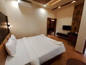 Ένα ή περισσότερα κρεβάτια σε δωμάτιο στο Shettar's Kusum Resort