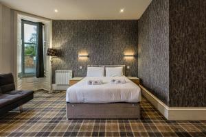 a hotel room with a bed and a couch at Crown Hotel & Bar in Inverness