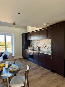 a kitchen with wooden cabinets and a table in a room at Luxury Apartment in Shropshire sleeps 4 in Shrewsbury