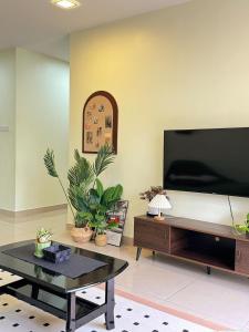 a living room with a large flat screen tv at Tea Valley & Farm View at Cool Summer Cameron in Cameron Highlands