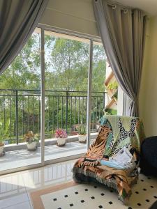 a living room with a couch and a large window at Tea Valley & Farm View at Cool Summer Cameron in Cameron Highlands