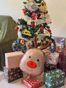 a christmas tree with presents and a reindeer toy at Tea Valley & Farm View at Cool Summer Cameron in Cameron Highlands +46 photos