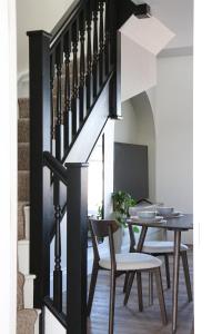 a dining room with a table and chairs under a staircase at Luxury Apartment in Shropshire sleeps 4 in Shrewsbury