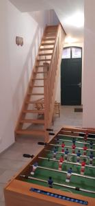 a staircase with a green table in the middle of a room at L'abbevilloise, aux portes de la Baie de Somme in Abbeville