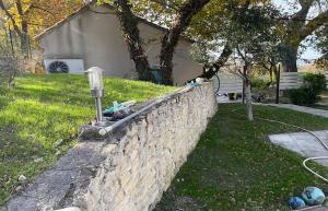 a stone retaining wall with a meter on it at Gîte du Jonquas in Velleron