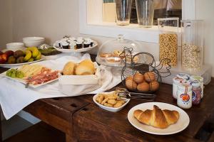 una mesa cubierta con placas de pan y otros alimentos en Gigante Wine & Welcome, en Corno di Rosazzo