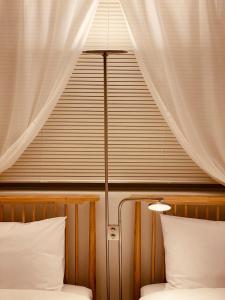 a bedroom with a window with white curtains at 아늑하고 조용한 신축 숙소 Stay Hyun301 in Seoul