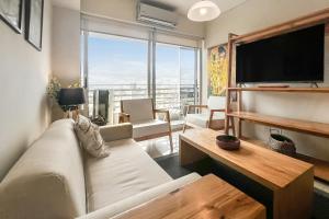 a living room with a couch and a flat screen tv at San Telmo Suites 12 in Buenos Aires