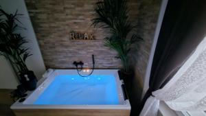 a bath tub in a room with two plants at Superior Suite, Villa Joy Verona, Luxury Romantic Suite with Jacuzzi, near City Center in Verona +18 photos