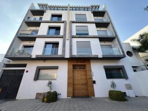 ein Mehrfamilienhaus mit einer braunen Tür in der Unterkunft Appart hôtel las jemelas in Casablanca