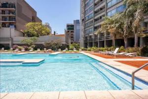 a large swimming pool in the middle of a building at San Telmo Suites 12 in Buenos Aires