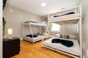 two bunk beds in a room with wooden floors at 558-3 3BR Boston - Modern Nest near Franklin Park in Boston