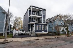 a blue house with a white van parked in front of it at 558-3 3BR Boston - Modern Nest near Franklin Park in Boston