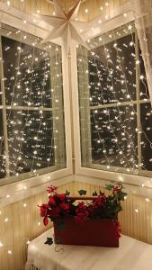 a room with a window with christmas lights at Peaceful house for relaxing in Oulu