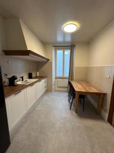 富瓦La Parenthèse à Foix的带木桌的厨房和餐厅