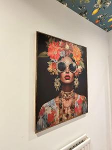 a painting of a woman with sunglasses on a wall at The Carlton Heights by The HIve WA1 in Warrington